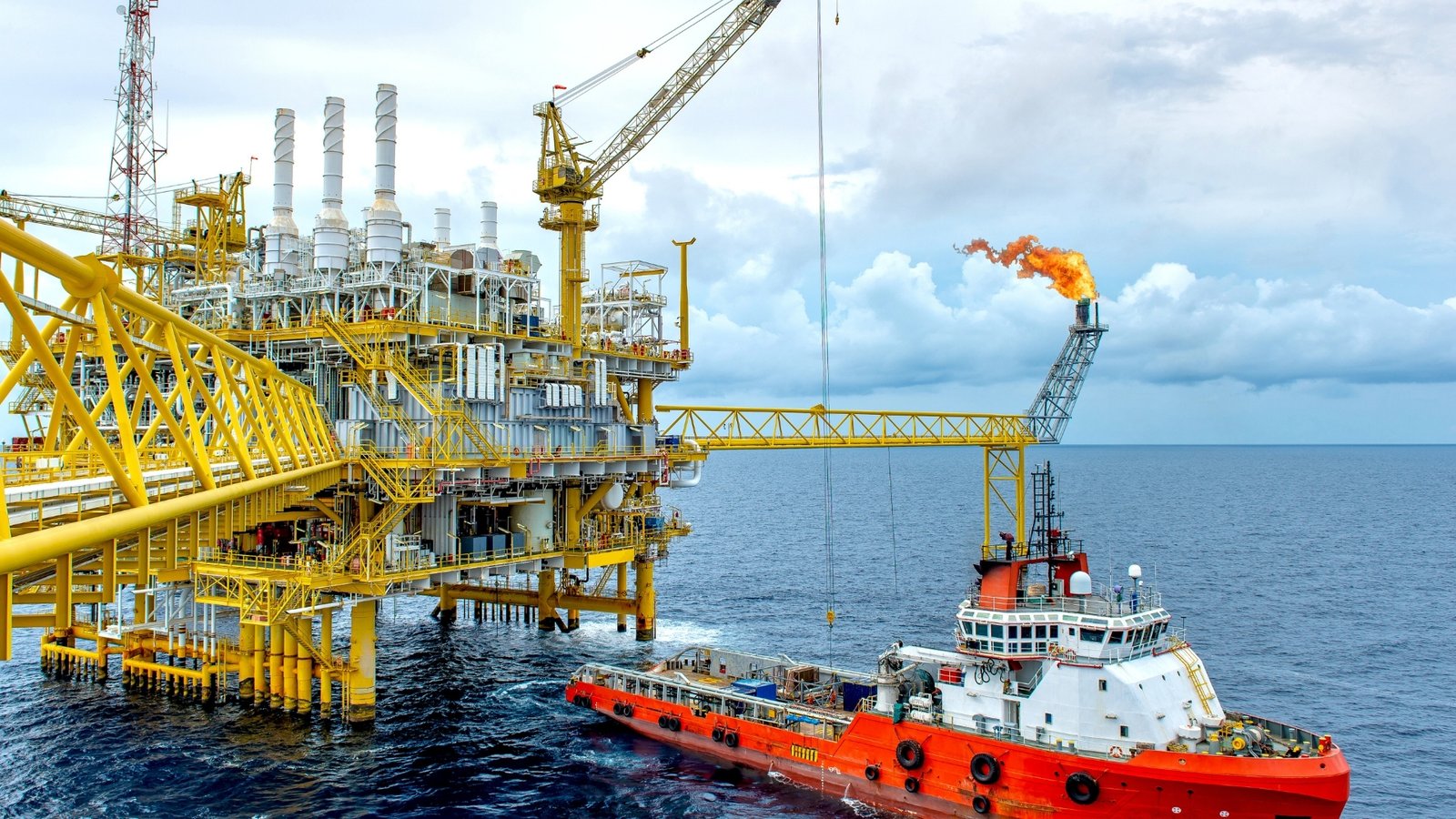 An offshore production platform flaring gas at sea, the upstream capacity OPEC+ is now auditing to set each member's 2027 baseline.